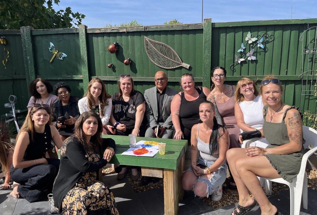 A group gathered around a table in the Centre garden
