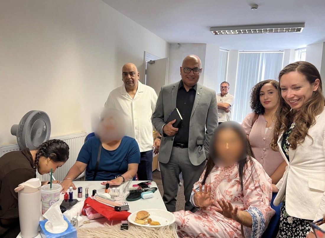 Visitors and attendees during an indoor activity session, with some faces blurred